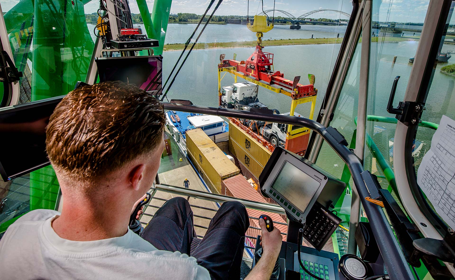 Crane operator at work unloads special cargo from inland vessel
